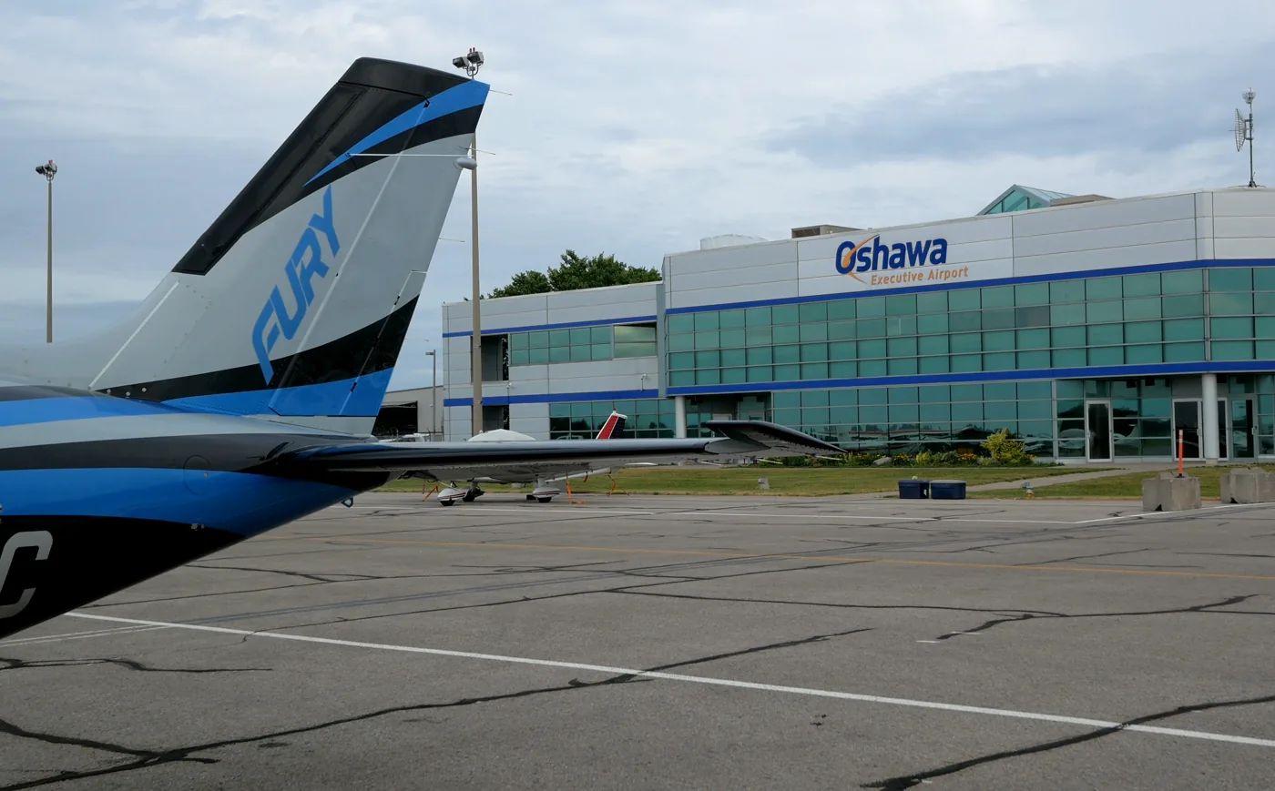 A NectAir aircraft on the ramp at Oshawa Executive Airport, the terminal behind it